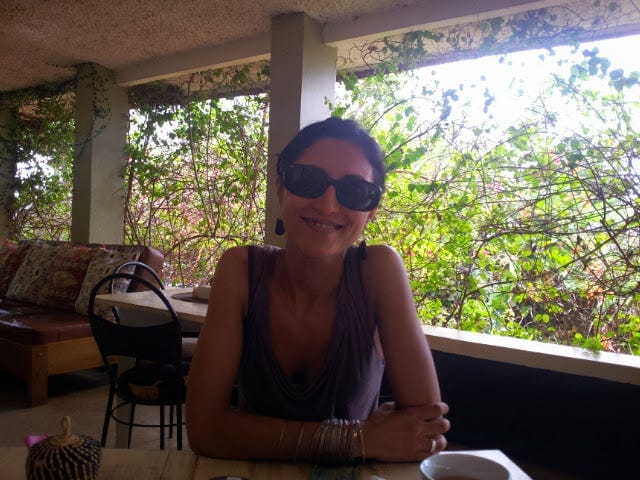 Writer of the piece, Aliya Mughal, sat in a cafe in Uganda